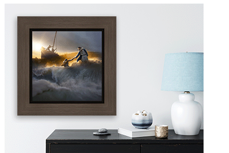 The elegant framed Christ painting from Altus Fine Arts graces a white wall above a sleek black table adorned with a blue lamp and tasteful decorative items.