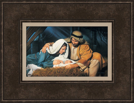 Joseph and Mary look at baby Jesus as he sleeps in the manger.