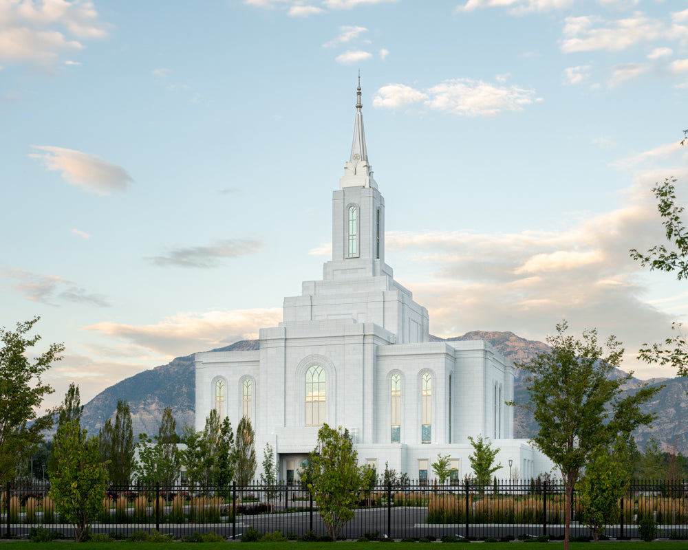 The Orem Utah Temple in the evening with the mountains.