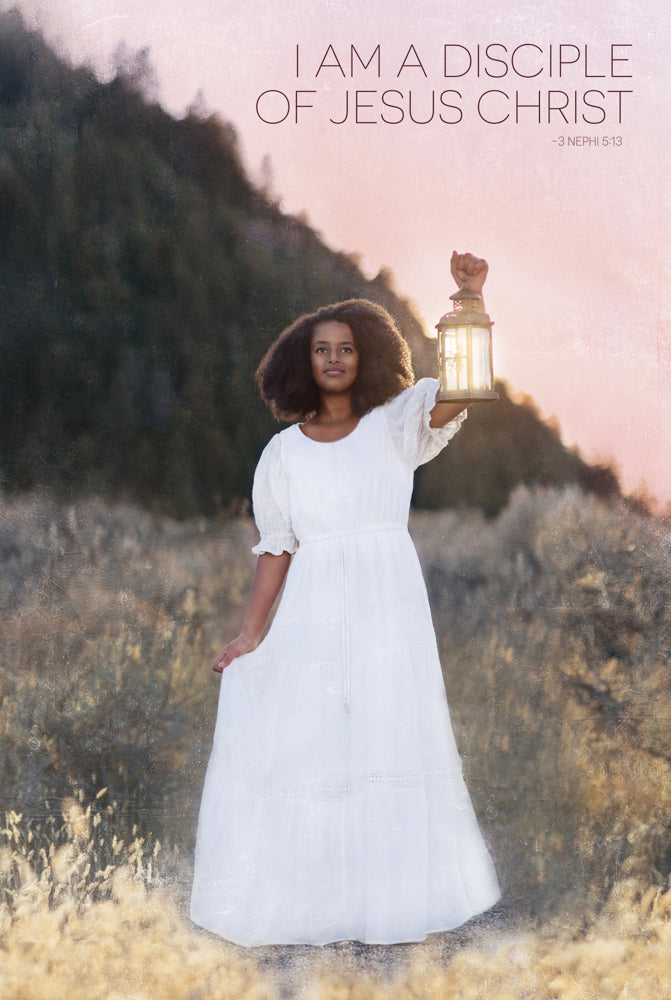 A woman in a white dress holds up a lantern.