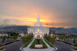 The Orem Utah Temple with the sunset over the mountains.