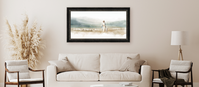 Beautiful framed artwork of Jesus guiding sheep, hanging on a neutral-toned living room wall, symbolizing faith and pastoral care.