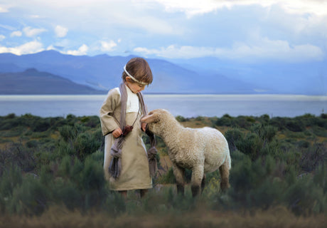 Young Jesus Christ walking with a lamb.