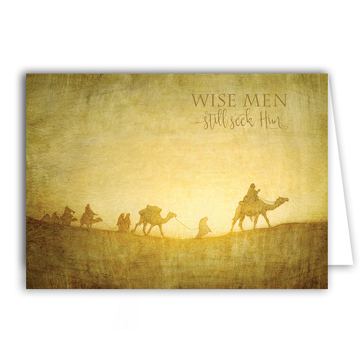 A Christmas card showcasing a desert scene with camels and people in a caravan.