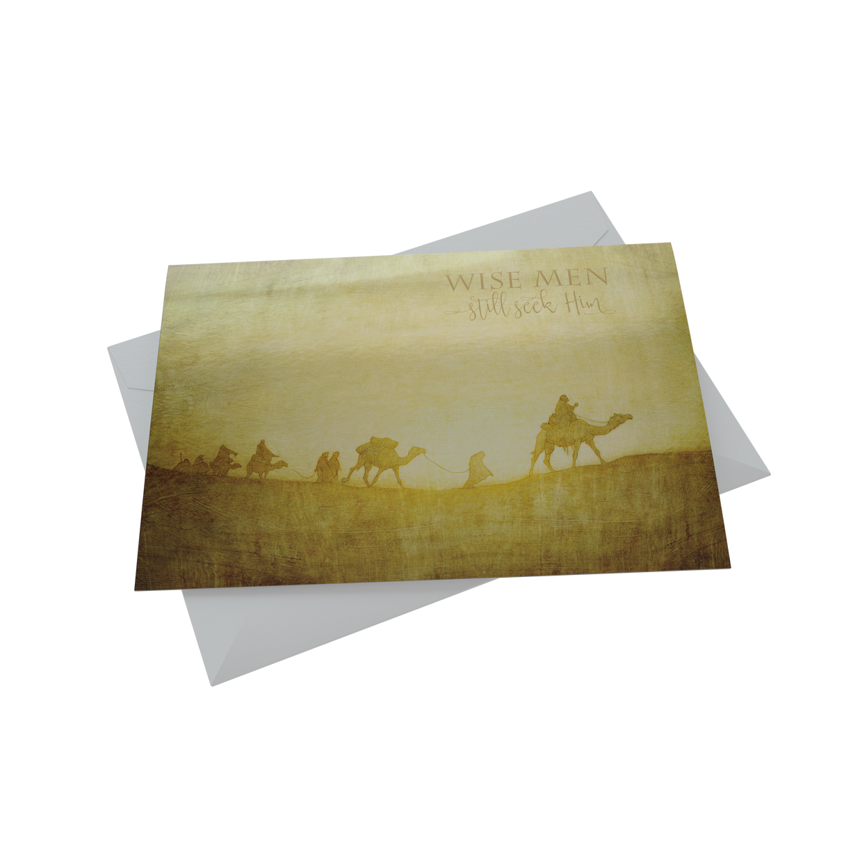 A Christmas card depicting a caravan scene with camels and people, celebrating the holiday in a desert setting.