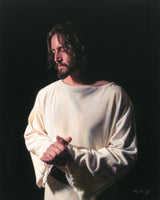 Portrait of Jesus with hands together against a black background. 