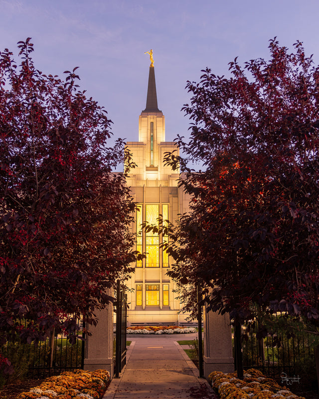 The Calgary Alberta Temple framed by red foliage in the fall.